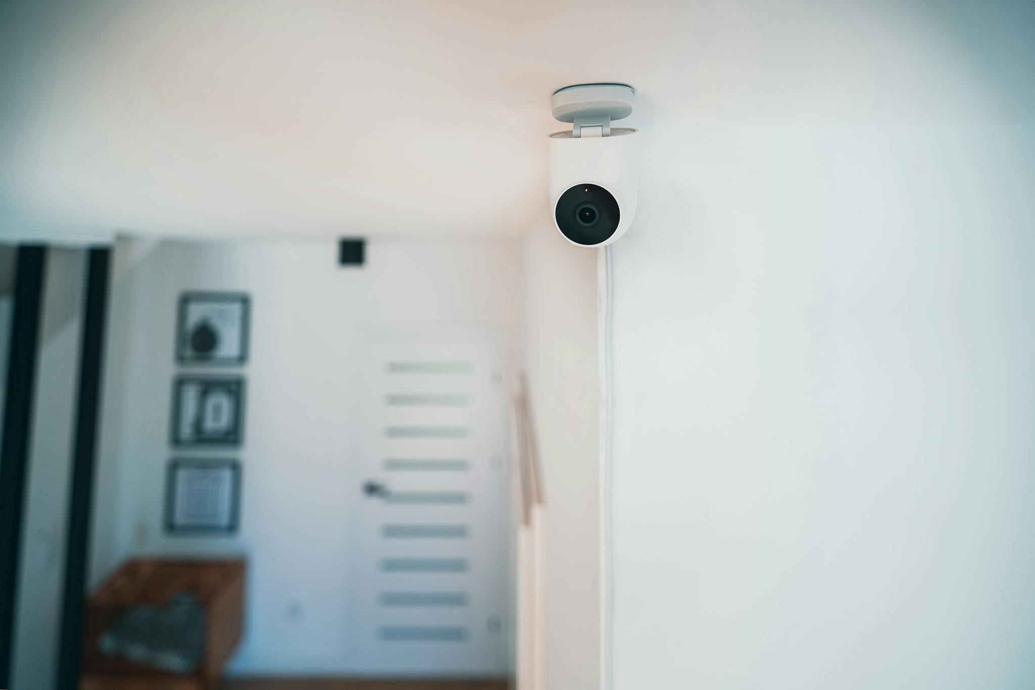 A sleek indoor security camera installed in a contemporary home for monitoring and safety.